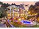 Spacious backyard with a pool, spa, and fire pit, perfect for outdoor entertaining with lovely landscaping at 4385 Ten Shillings Way, Ravenel, SC 29470