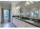 This bathroom features double sinks with granite countertops, white cabinets, and plenty of lighting at 4385 Ten Shillings Way, Ravenel, SC 29470