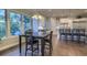 Open dining area with hardwood floors and natural light flowing in from the oversized windows at 4385 Ten Shillings Way, Ravenel, SC 29470