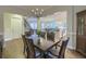 Open dining room with hardwood floors, a chandelier, and views into the kitchen and living room at 4385 Ten Shillings Way, Ravenel, SC 29470