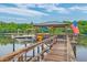 Boat sitting at dock, featuring shelter, an American flag, and watercraft accessories at 4385 Ten Shillings Way, Ravenel, SC 29470