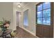 Elegant entryway with hardwood floors, a decorative table, and a view of the front door at 4385 Ten Shillings Way, Ravenel, SC 29470
