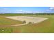 Spacious equestrian field featuring multiple jumps and a well-maintained sand surface at 4385 Ten Shillings Way, Ravenel, SC 29470