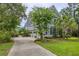 Charming two-story home with well-manicured lawn, mature trees, and a long, inviting driveway at 4385 Ten Shillings Way, Ravenel, SC 29470