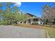 Sprawling home with covered porch and brick driveway offers classic elegance and charm at 4385 Ten Shillings Way, Ravenel, SC 29470