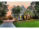 Charming two-story home featuring a manicured lawn, mature trees and a long driveway at 4385 Ten Shillings Way, Ravenel, SC 29470