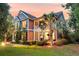 Charming two-story home with a welcoming front porch and manicured landscaping, offering great curb appeal at 4385 Ten Shillings Way, Ravenel, SC 29470