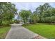 Charming two-story home with well-manicured lawn, mature trees, and a long, inviting driveway at 4385 Ten Shillings Way, Ravenel, SC 29470