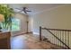 Well-lit upstairs hallway boasting hardwood floors and a staircase leading to other levels at 4385 Ten Shillings Way, Ravenel, SC 29470
