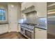 Gourmet kitchen with stainless steel range, custom backsplash, and white cabinetry at 4385 Ten Shillings Way, Ravenel, SC 29470