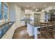 Spacious kitchen with white cabinets, granite countertops, stainless steel appliances, and a center island at 4385 Ten Shillings Way, Ravenel, SC 29470