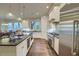 Bright kitchen featuring stainless steel appliances, a large island, and hardwood flooring at 4385 Ten Shillings Way, Ravenel, SC 29470