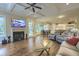Open concept living room with hardwood floors, fireplace, and view into the dining and kitchen area at 4385 Ten Shillings Way, Ravenel, SC 29470