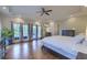 Spacious main bedroom with hardwood floors, tray ceiling, and access to a private balcony at 4385 Ten Shillings Way, Ravenel, SC 29470