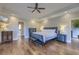 This main bedroom features hardwood floors, recessed lighting, and ceiling fan for comfort and style at 4385 Ten Shillings Way, Ravenel, SC 29470
