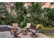 Cozy outdoor seating area features a fire pit, comfortable chairs, and serene views of the surrounding trees at 4385 Ten Shillings Way, Ravenel, SC 29470