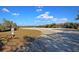 A very large empty gravel parking lot in a rural setting underneath a blue sky at 4385 Ten Shillings Way, Ravenel, SC 29470