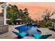 Lovely backyard pool area with lounge chairs, lighting, and lush landscaping perfect for relaxation at 4385 Ten Shillings Way, Ravenel, SC 29470
