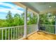 Covered porch with outdoor furniture and peaceful tree views at 4385 Ten Shillings Way, Ravenel, SC 29470