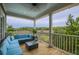 Covered porch with comfortable seating and scenic marsh views at 4385 Ten Shillings Way, Ravenel, SC 29470