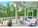 Inviting screened porch with comfortable seating and scenic views of the surrounding trees and lush landscape at 4385 Ten Shillings Way, Ravenel, SC 29470