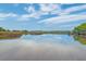 Serene waterfront view highlighting the tranquil waterway and natural landscape on a sunny day at 4385 Ten Shillings Way, Ravenel, SC 29470