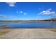 Scenic waterfront view with a boat ramp under a blue sky, perfect for outdoor activities at 4385 Ten Shillings Way, Ravenel, SC 29470