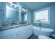 Bright bathroom with granite countertops, dual sinks, and soaking tub under a large window at 4991 Lake Palmetto Ln, North Charleston, SC 29418