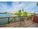 Relaxing wood deck overlooking a serene lake with a view of nearby townhomes at 4991 Lake Palmetto Ln, North Charleston, SC 29418