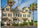 Charming townhouse showcases a welcoming facade with neat landscaping and two palm trees in the front at 4991 Lake Palmetto Ln, North Charleston, SC 29418