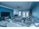 Cozy living room features a plush sofa, fireplace, ceiling fan, and access to an outdoor patio at 4991 Lake Palmetto Ln, North Charleston, SC 29418