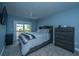 Cozy main bedroom with balcony access, dresser and soft carpet at 4991 Lake Palmetto Ln, North Charleston, SC 29418