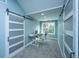 Bright office space with gray walls, sliding barn doors, desk, and a window for natural light at 4991 Lake Palmetto Ln, North Charleston, SC 29418