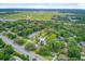 Aerial view of homes in a treed neighborhood near a scenic marsh and roadway at 501 Joseph St, Charleston, SC 29412