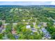 Aerial view shows the neighborhood's layout with tree-lined streets, the golf course, and the serene waterway in the distance at 501 Joseph St, Charleston, SC 29412