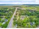 Aerial view showcasing homes in a lush, green neighborhood near a highway and waterway at 501 Joseph St, Charleston, SC 29412