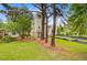 Expansive backyard view featuring mature trees and a well-maintained lawn at 501 Joseph St, Charleston, SC 29412