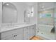 Stylish bathroom with a tub, shower with glass door, dual sinks, and modern lighting at 501 Joseph St, Charleston, SC 29412