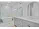Modern bathroom featuring dual sinks, a glass-enclosed shower, and a soaking tub at 501 Joseph St, Charleston, SC 29412