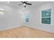 Sunlit bedroom featuring two windows, modern lighting, and neutral walls creating a serene space at 501 Joseph St, Charleston, SC 29412
