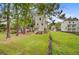Exterior shot showcasing the side and rear of the property, including a spacious, green backyard at 501 Joseph St, Charleston, SC 29412