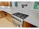 Kitchen featuring an oven range top, tile backsplash, light countertops, and light-colored cabinets at 501 Joseph St, Charleston, SC 29412