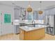 Modern kitchen with stainless steel appliances, wooden island, and stylish hanging lights at 501 Joseph St, Charleston, SC 29412
