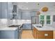 Contemporary kitchen showcasing stainless steel appliances, blue cabinets, and a wooden island at 501 Joseph St, Charleston, SC 29412