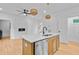 Open-concept room with a fireplace and kitchen featuring stainless steel appliances at 501 Joseph St, Charleston, SC 29412