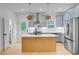 Modern kitchen with stainless steel appliances, wooden island, and stylish hanging lights at 501 Joseph St, Charleston, SC 29412
