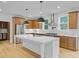 Open-concept kitchen with stainless appliances, wooden cabinets, white counters and a kitchen island with a sink at 501 Joseph St, Charleston, SC 29412