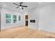Modern living room featuring hardwood floors, fireplace, and large windows offering natural light at 501 Joseph St, Charleston, SC 29412