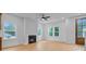 Bright living room with light wood floors, modern fireplace and windows that have a view of the outdoors at 501 Joseph St, Charleston, SC 29412