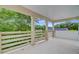 Patio featuring white columns and railings with wooded backyard views at 501 Joseph St, Charleston, SC 29412